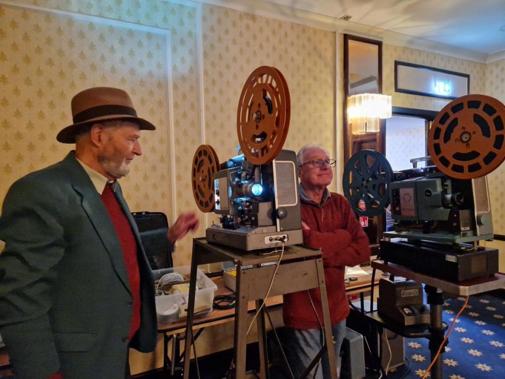 Projectionists Nigel Lister and Jim Cecil with two 16mm film projectors.
